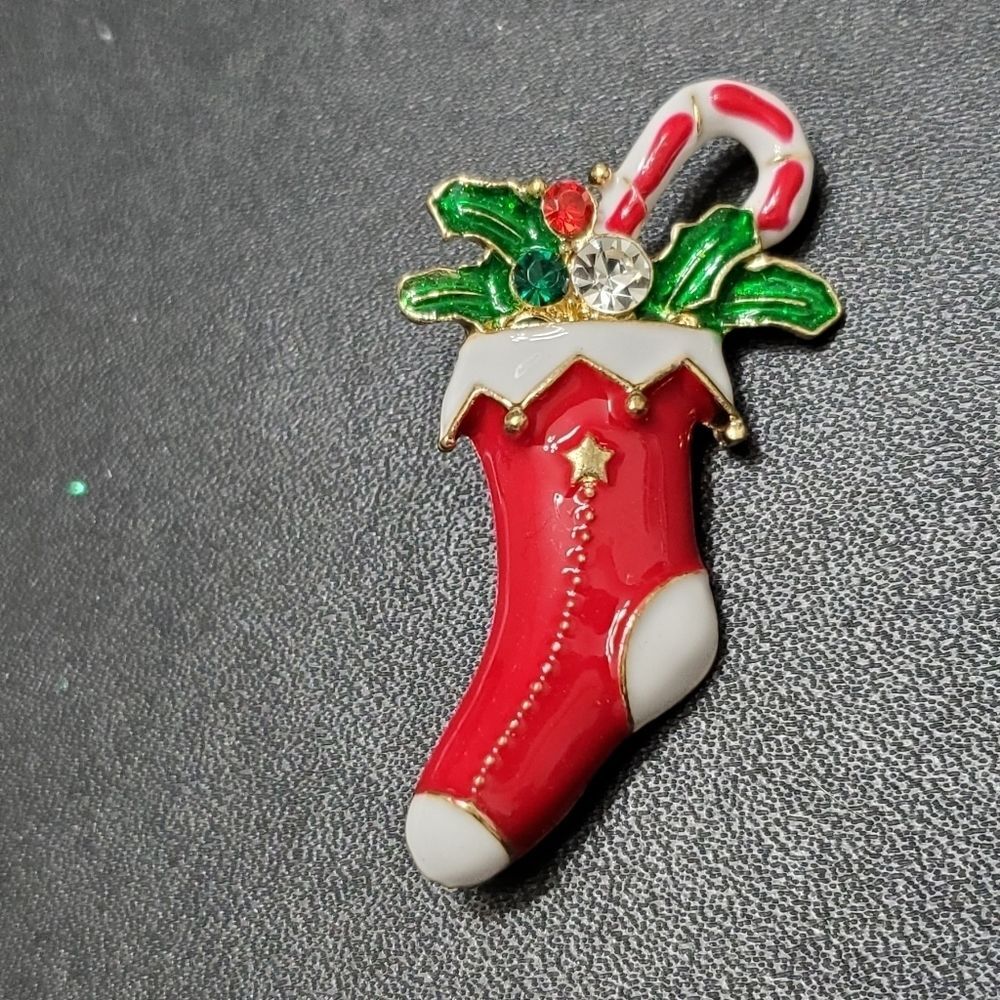 Gold tone holiday stocking filled with goodies red green white